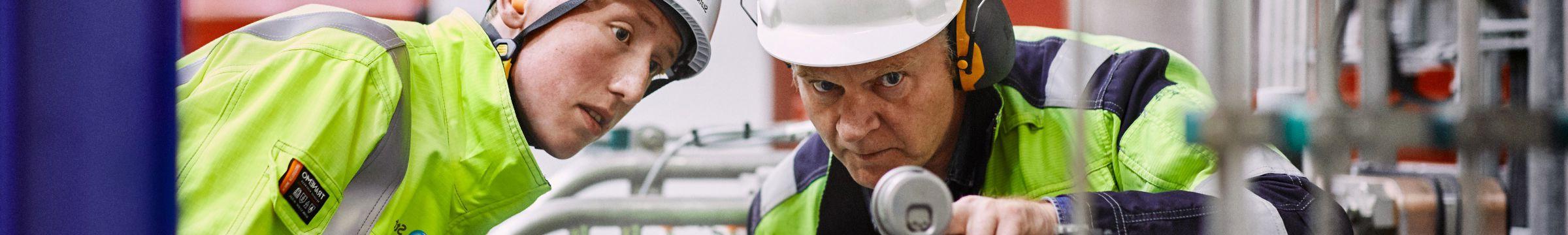 Employees looking at equipment at Ringendalen power plant in Norway